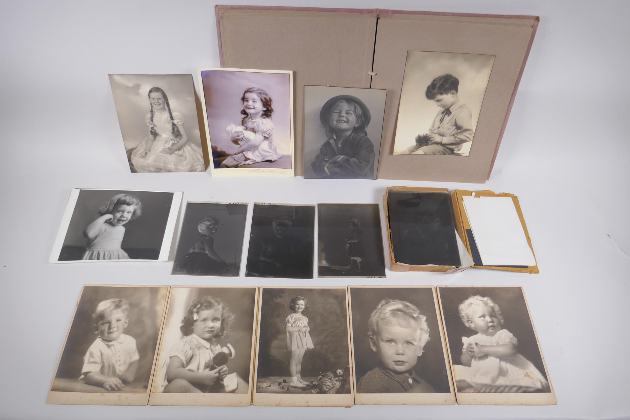 A collection of glass plate negative portraits and photographic prints of children by Marcus