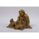 A Chinese filled brass figure of a seated lohan, 18cm wide