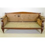An early C19th mahogany settee in the manner of Thomas King classical style with carved
