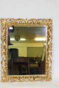 A vintage gilt plaster Florentine style wall mirror, 65 x 76cm