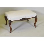 A Victorian rosewood foot stool, upholstered in a linen cover with an embroidered monogram, the