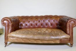 A leather chesterfield settee, raised on shaped beechwood supports, horse hair stuffed, springs need