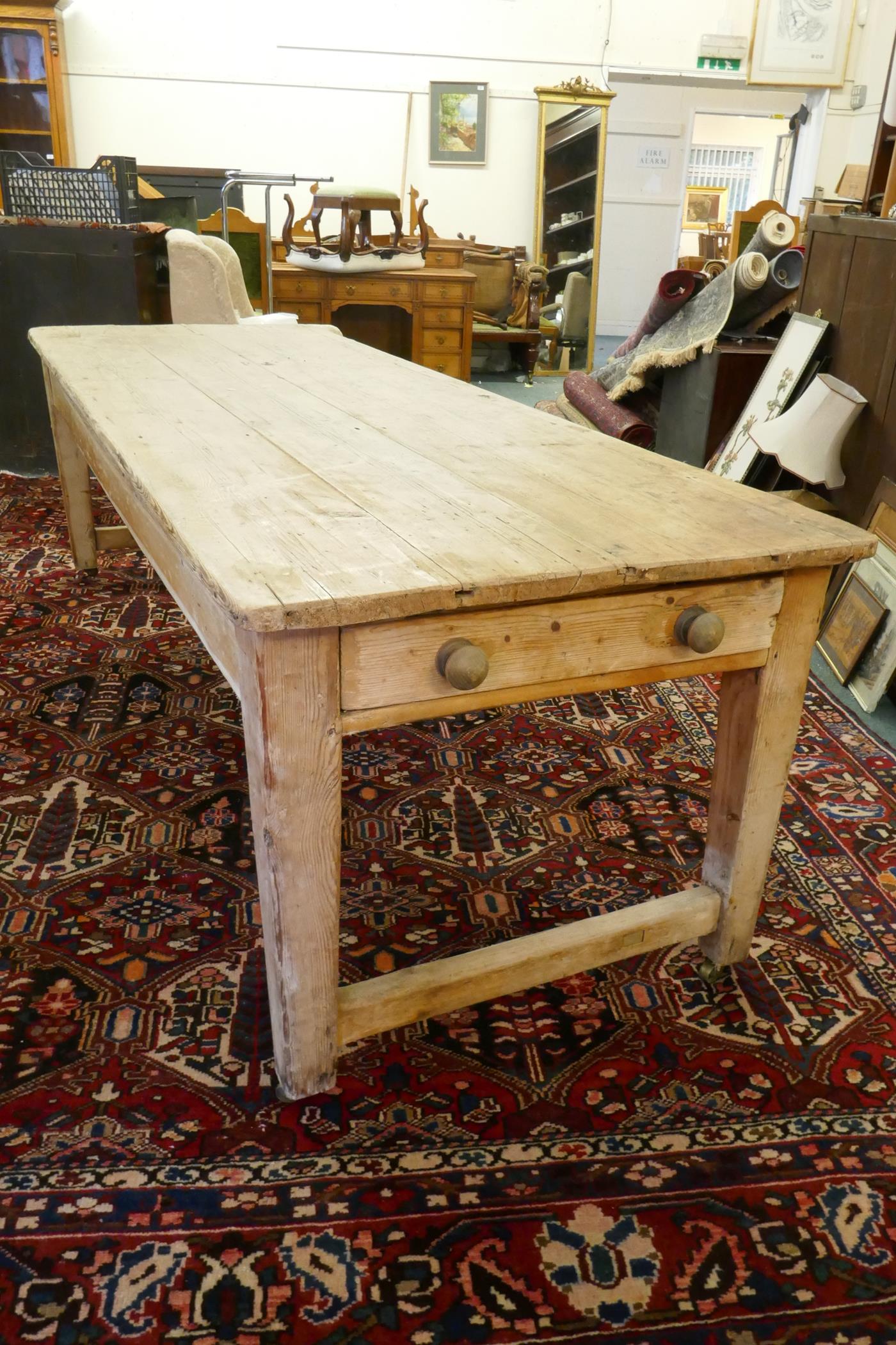 A large Victorian pine scullery table with plank top and end drawers, raised on square tapering - Image 5 of 6