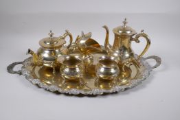 A silver plated tea set, comprising teapot, coffee pot,milk jug, two sugar pots and a tray, tray