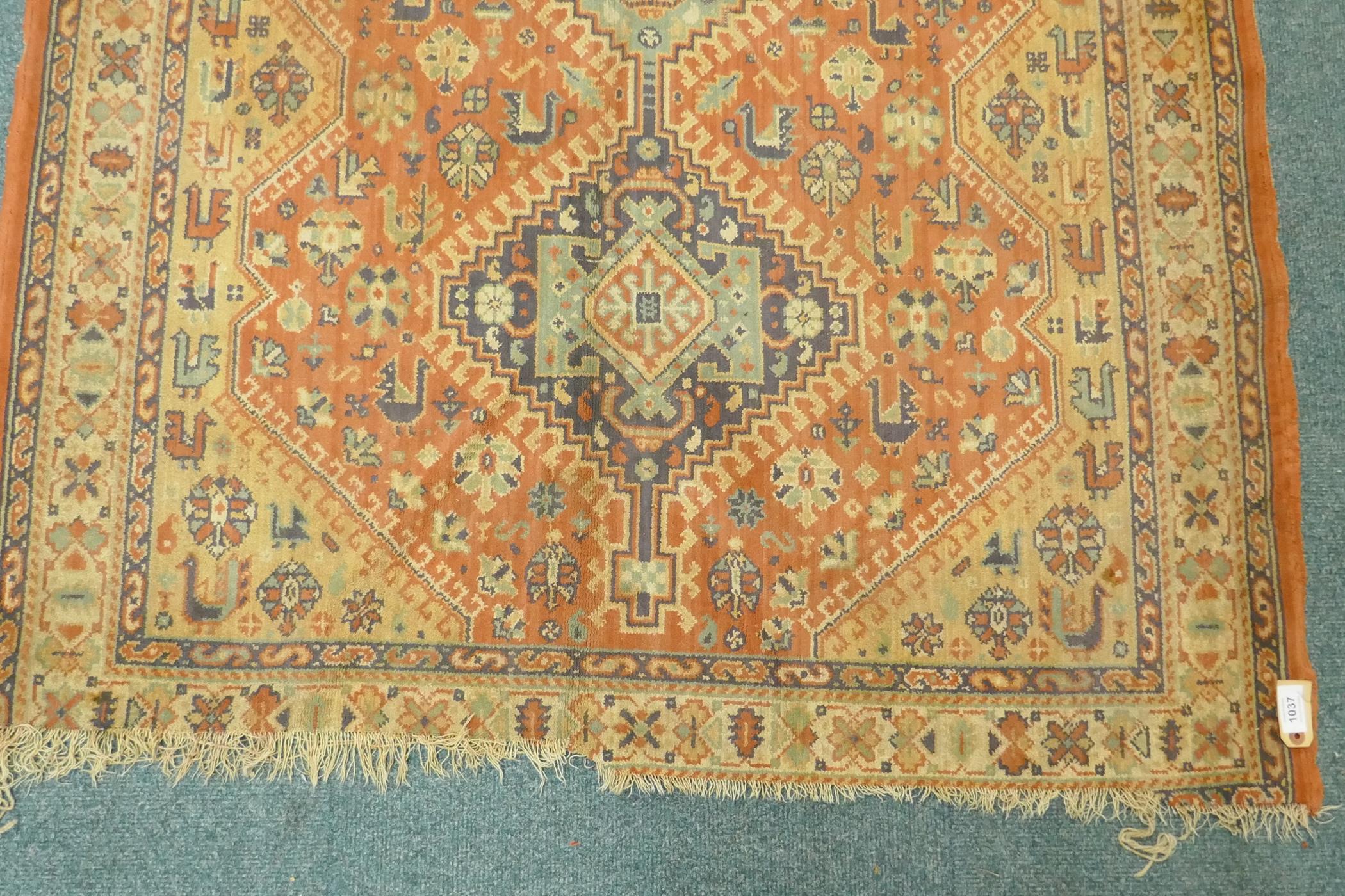 A Middle Eastern wool carpet with medallion design on a faded terracotta field, 160 x 110cm - Image 3 of 5