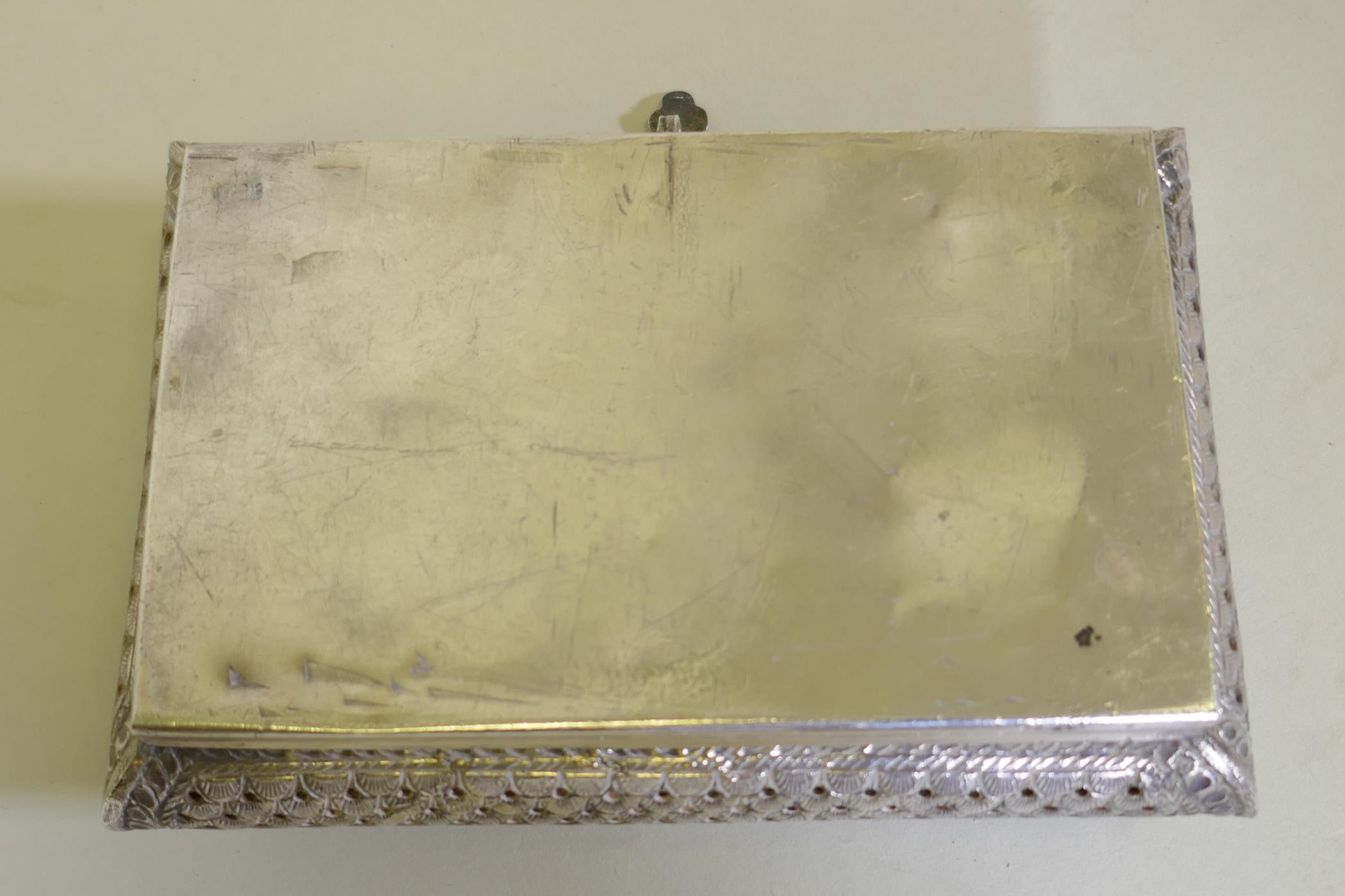 An oriental white metal cushion shaped box with engraved and pierced decoration, marked 'silver' - Image 3 of 5