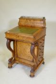 A Victorian burr walnut davenport, the upper section fitted with pigeon holes, letter racks and