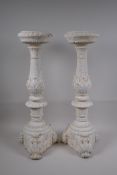 A pair of painted composition pricket candlesticks, 54cm high