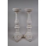 A pair of painted composition pricket candlesticks, 54cm high
