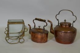 A Victorian copper kettle, 28cm high, and another smaller, and a brass casket with bevelled glass