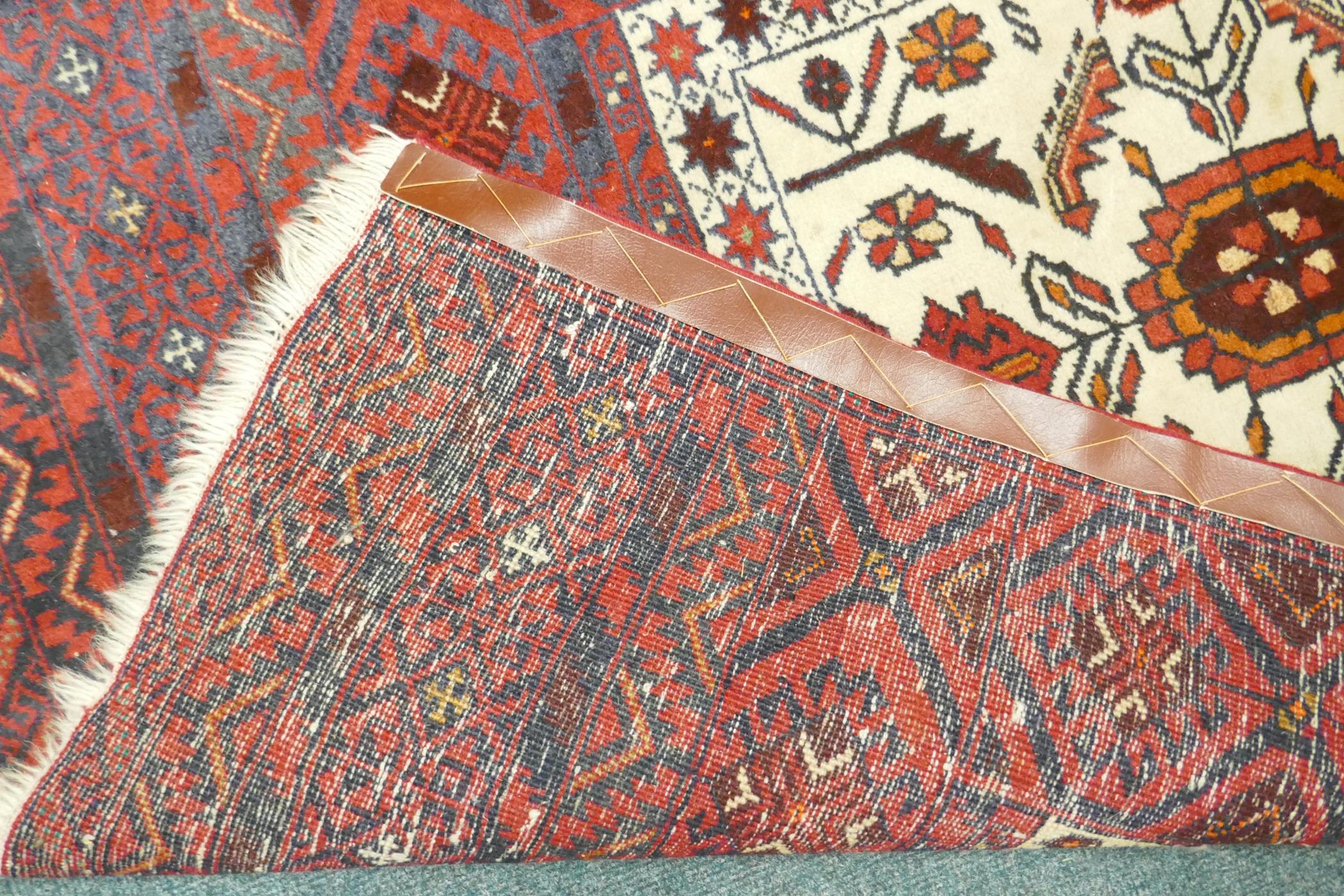 A Middle Eastern hand woven rug with red borders and central panel, with geometric floral designs - Image 3 of 3