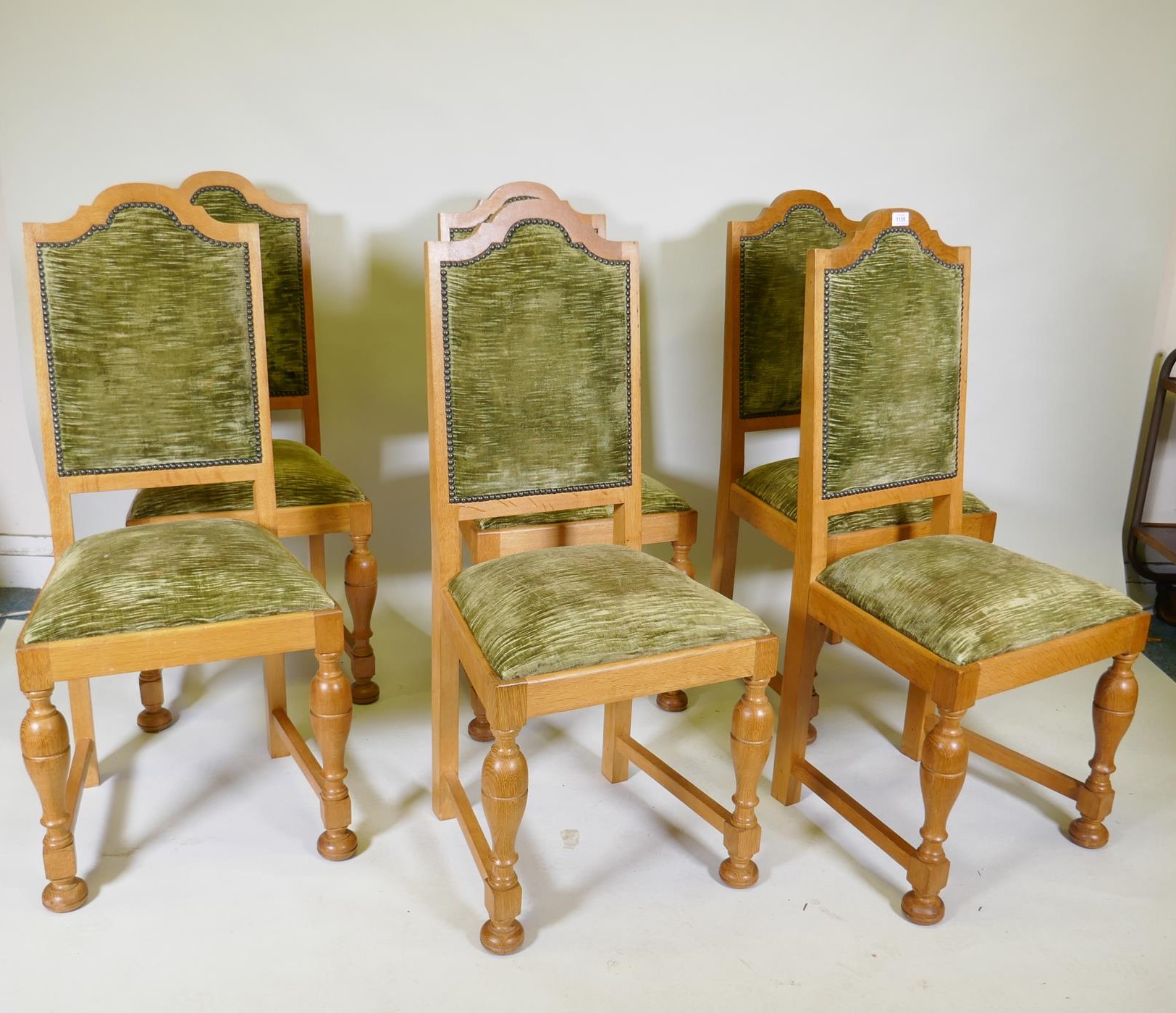 A set of six oak dining chairs with sprung seats