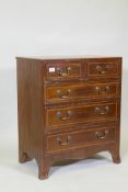 An inlaid mahogany chest of small proportions, two over three drawers, with brass swan neck handles,