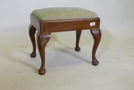 A C19th Georgian style footstool with drop in seat, raised on cabriole supports with pad feet, 47