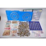 A quantity of assorted world coinage and banknotes, three commemorative footballing coin sets and an