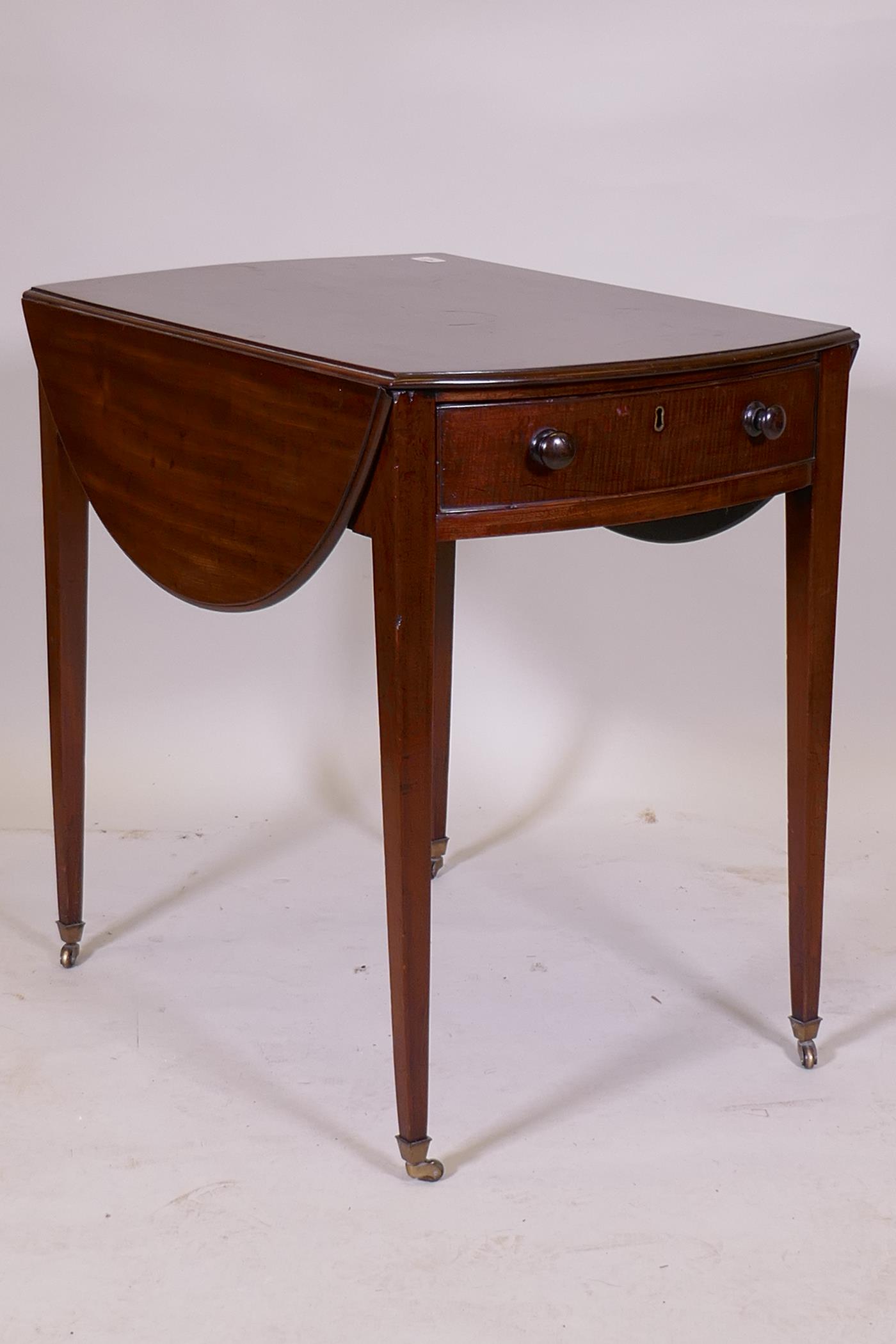 A George III mahogany Pembroke table with single drawer and bow ends, raised on square tapering