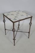 A wrought iron occasional table with an C18th delft tile top decorated with birds. Provenance: The