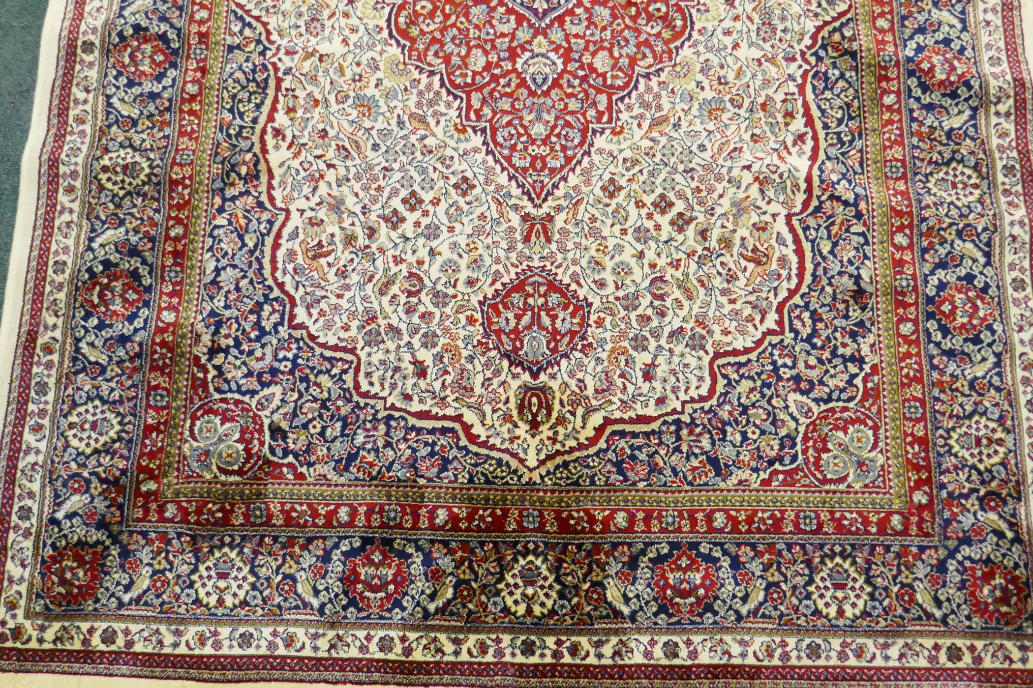 An ivory ground Kashmir carpet with central floral medallion design, 240 x 156cm - Image 2 of 5