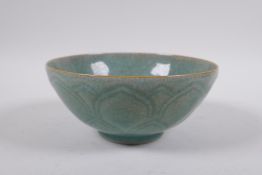 A Chinese celadon crackle glazed porcelain rice bowl with underglaze lotus flower decoration, 16cm