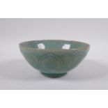 A Chinese celadon crackle glazed porcelain rice bowl with underglaze lotus flower decoration, 16cm