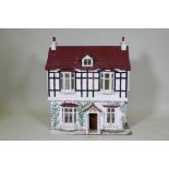 A scratch built dolls' house cottage, 68 x 42cm, 77cm high
