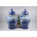 A pair of Chinese blue and white baluster shaped jars and covers with kylin decoration, 51cm high
