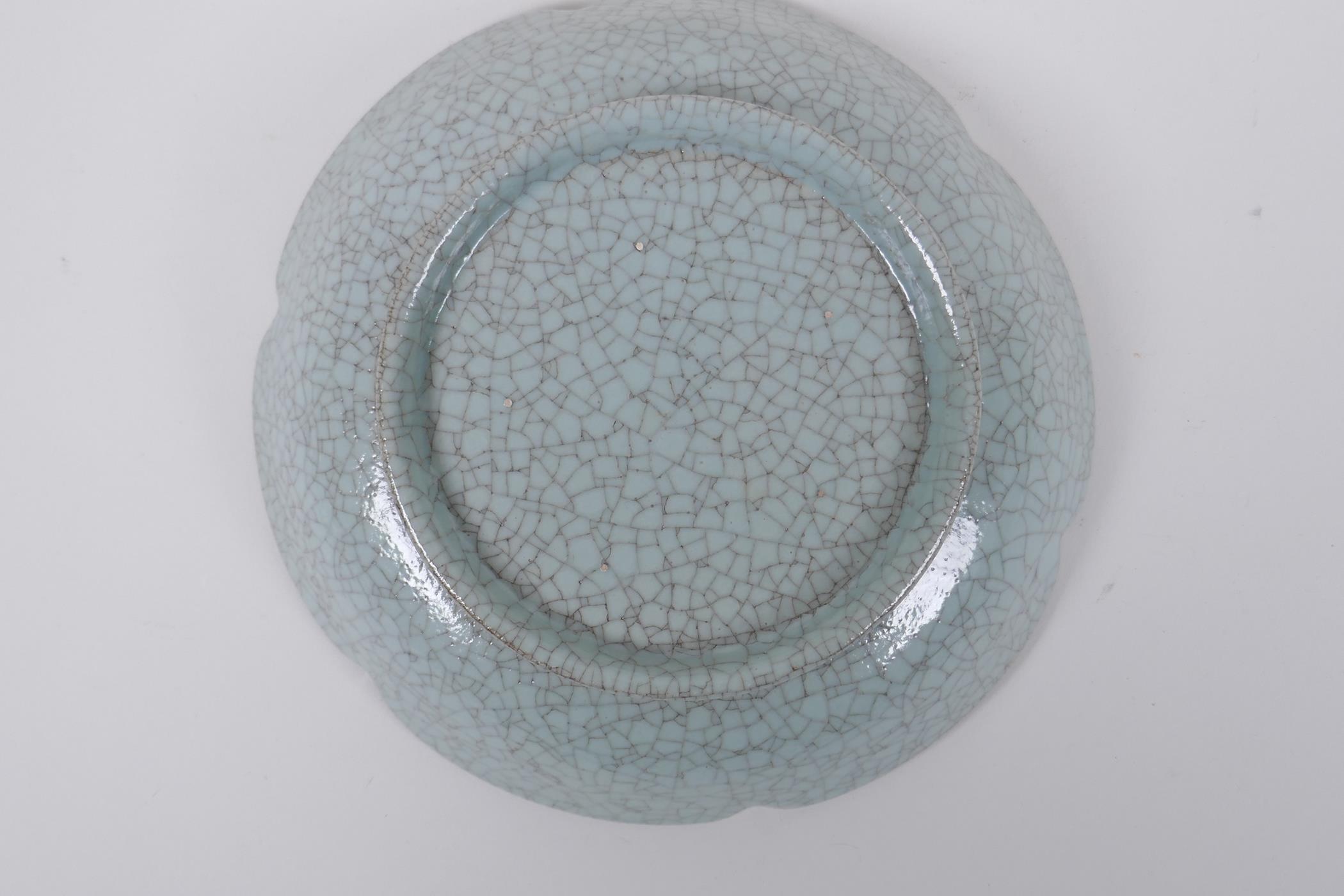 A Chinese celadon glazed porcelain dish with a petal shaped rim, AF, 19cm diameter - Image 4 of 4