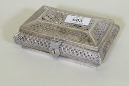 An oriental white metal cushion shaped box with engraved and pierced decoration, marked 'silver'