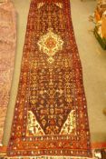 A large Persian full pile blue ground Sarouk runner with hand woven all over floral design, 420 x