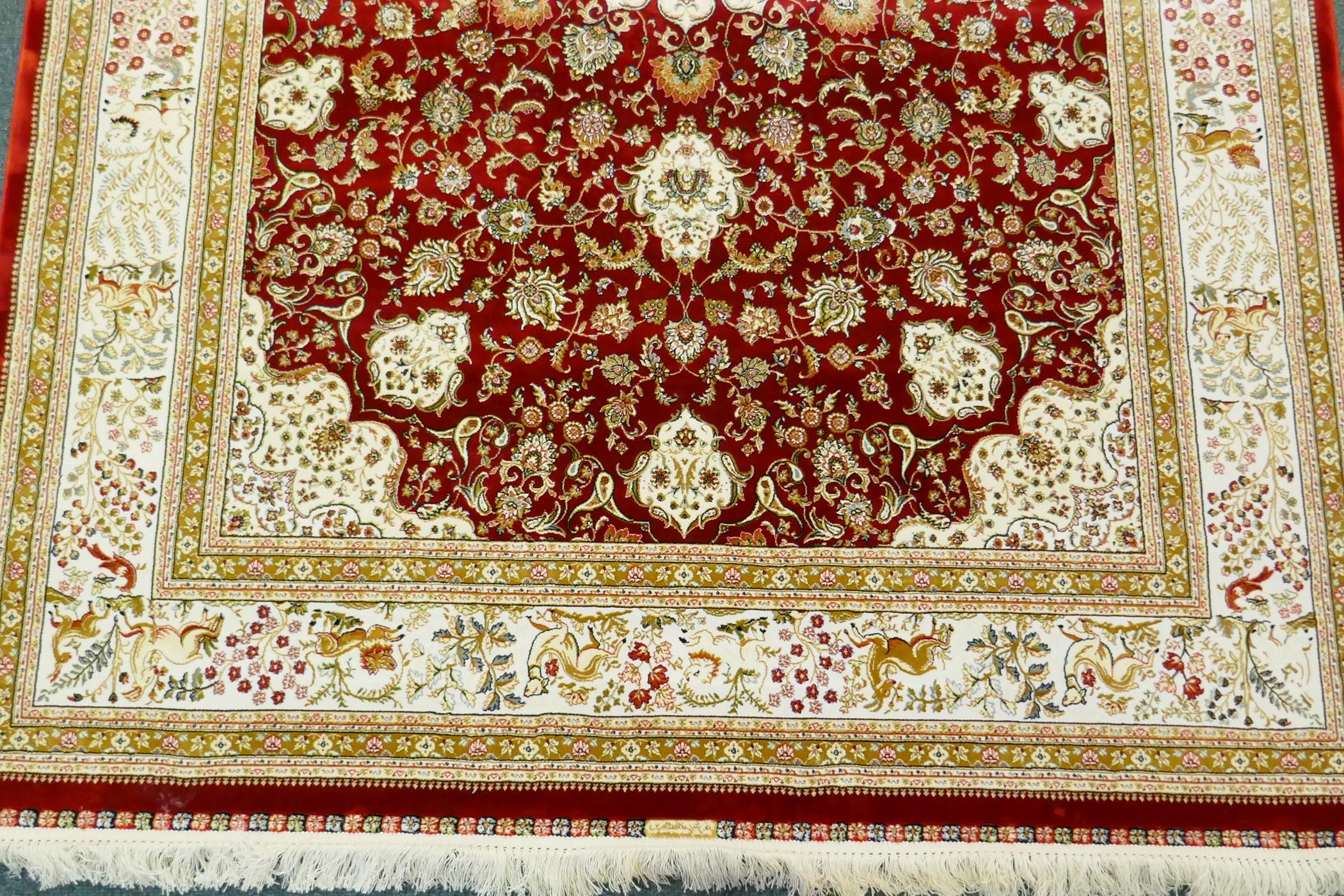 A Persian red ground full pile bamboo silk carpet with central floral medallion design and cream - Image 3 of 9