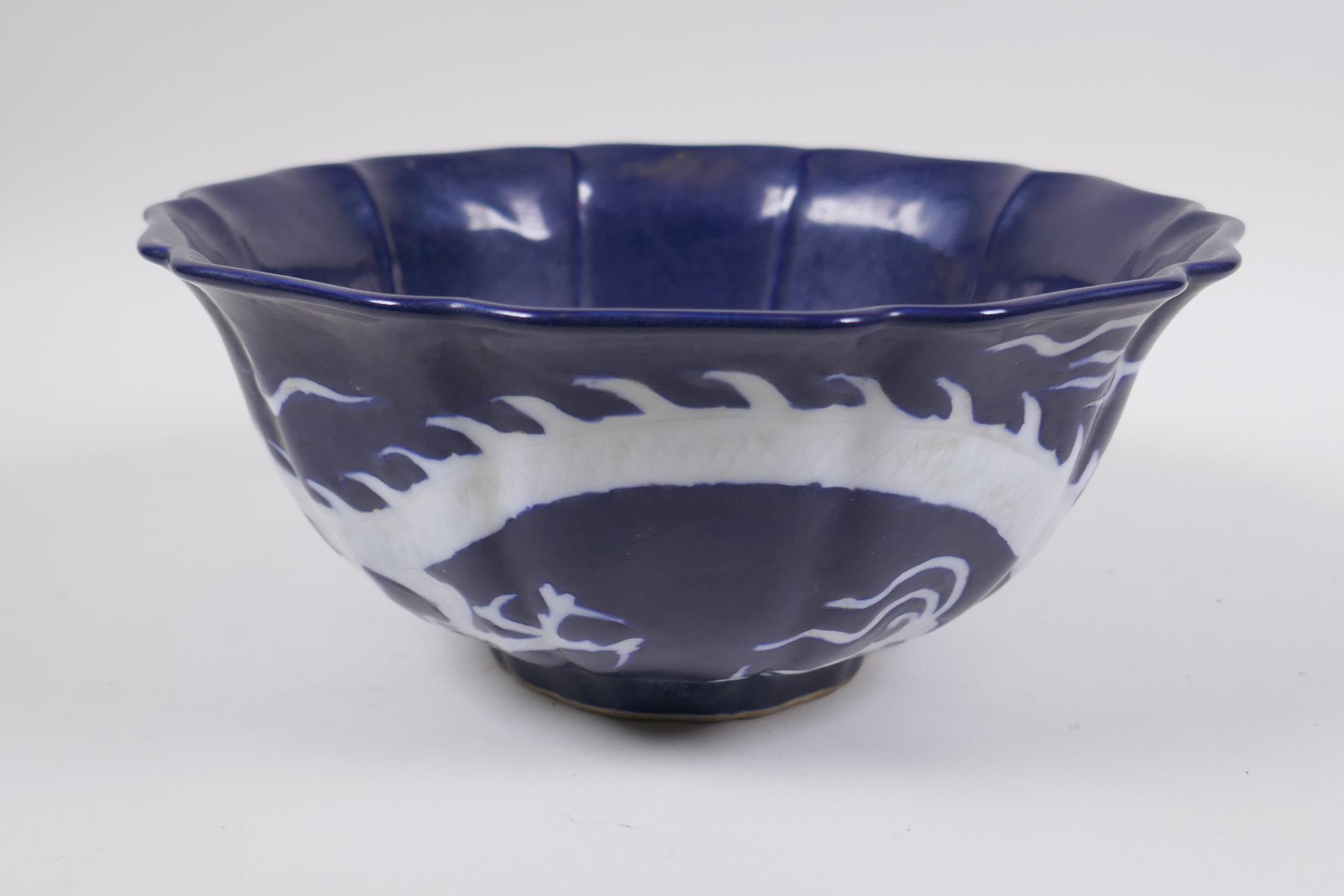 A Chinese blue and white porcelain steep sided bowl with lobed rim, decorated with a white dragon - Image 2 of 6