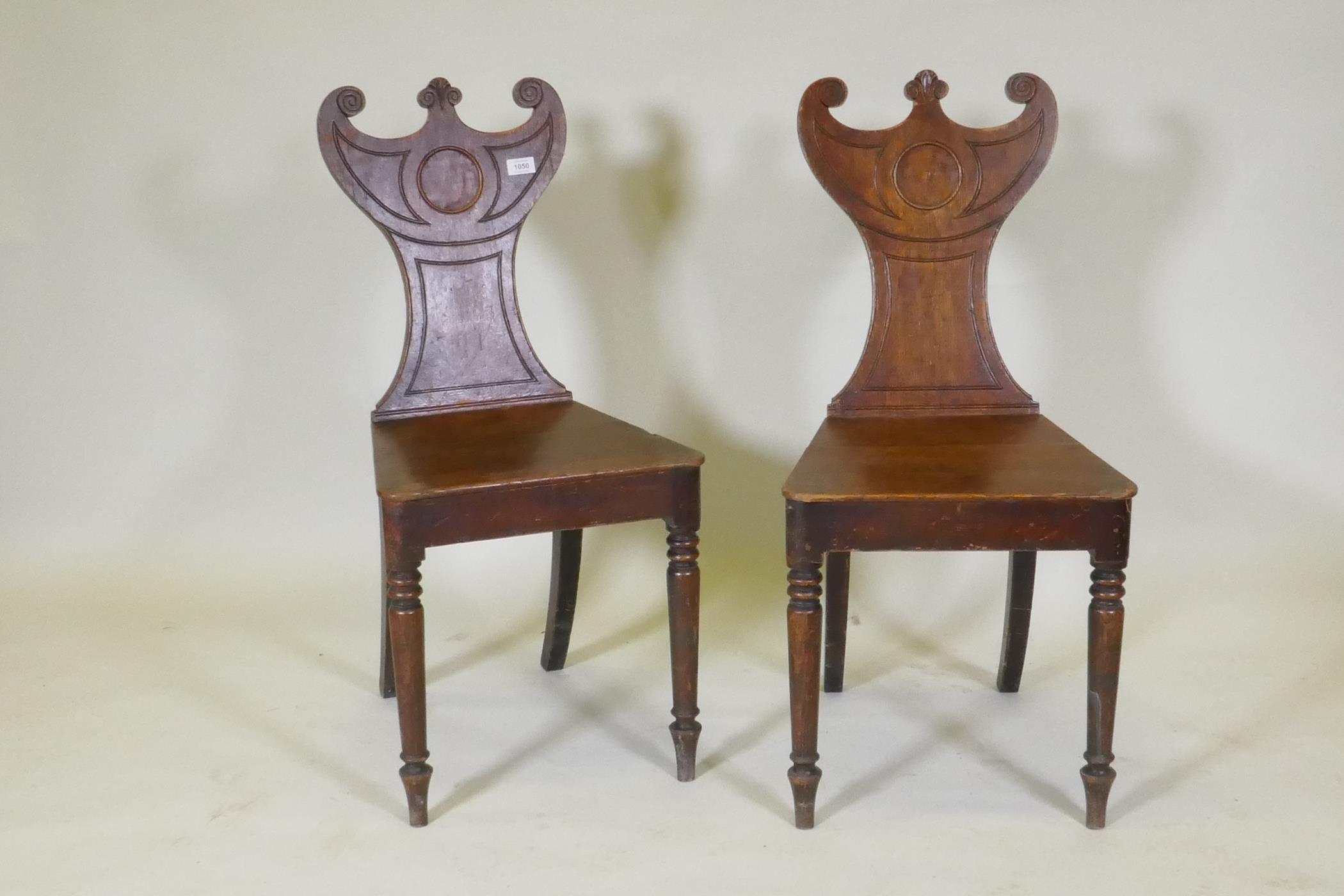A pair of Regency oak hall chairs with shaped backs, raised on turned tapering supports, 88cm high - Image 2 of 3