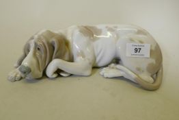A Lladro ceramic figure of a dog, 23cm long