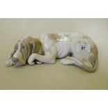A Lladro ceramic figure of a dog, 23cm long