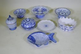 A collection of oriental porcelain with blue and white decoration, including footed bowls, jars