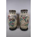 A pair of Japanese Satsuma pottery oil lamp base vases, painted with birds and flowers on carved