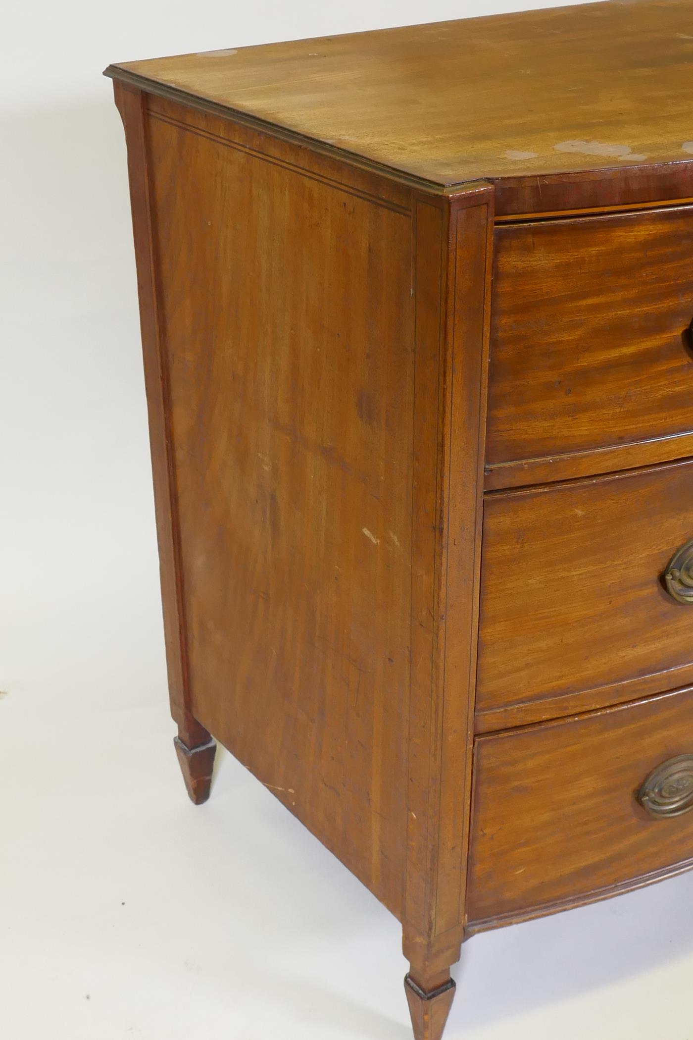 A C19th mahogany Sheraton style bow front chest of three long drawers with brass plate handles, - Image 5 of 9