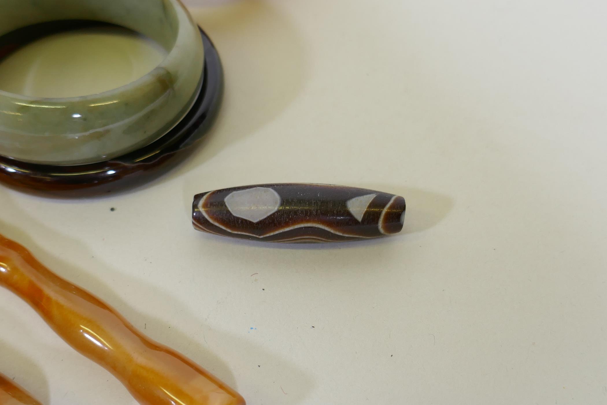 Six hardstone bangles, jadeite, agate and quartz, four cheroot holders and a dzi bead - Image 2 of 6