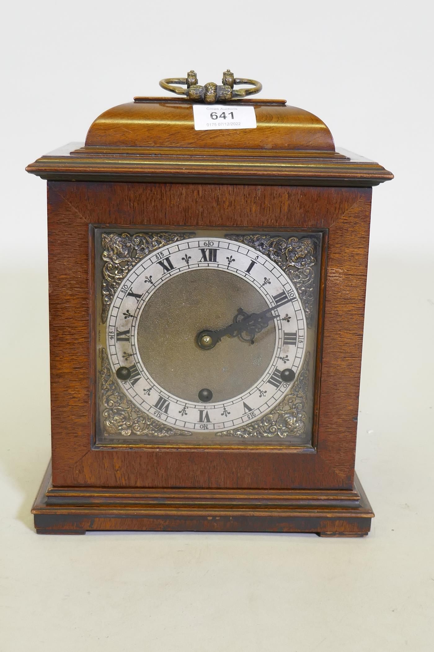 A mahogany case mantel clock with brass dial and silvered chapter ring, the Eight Day spring