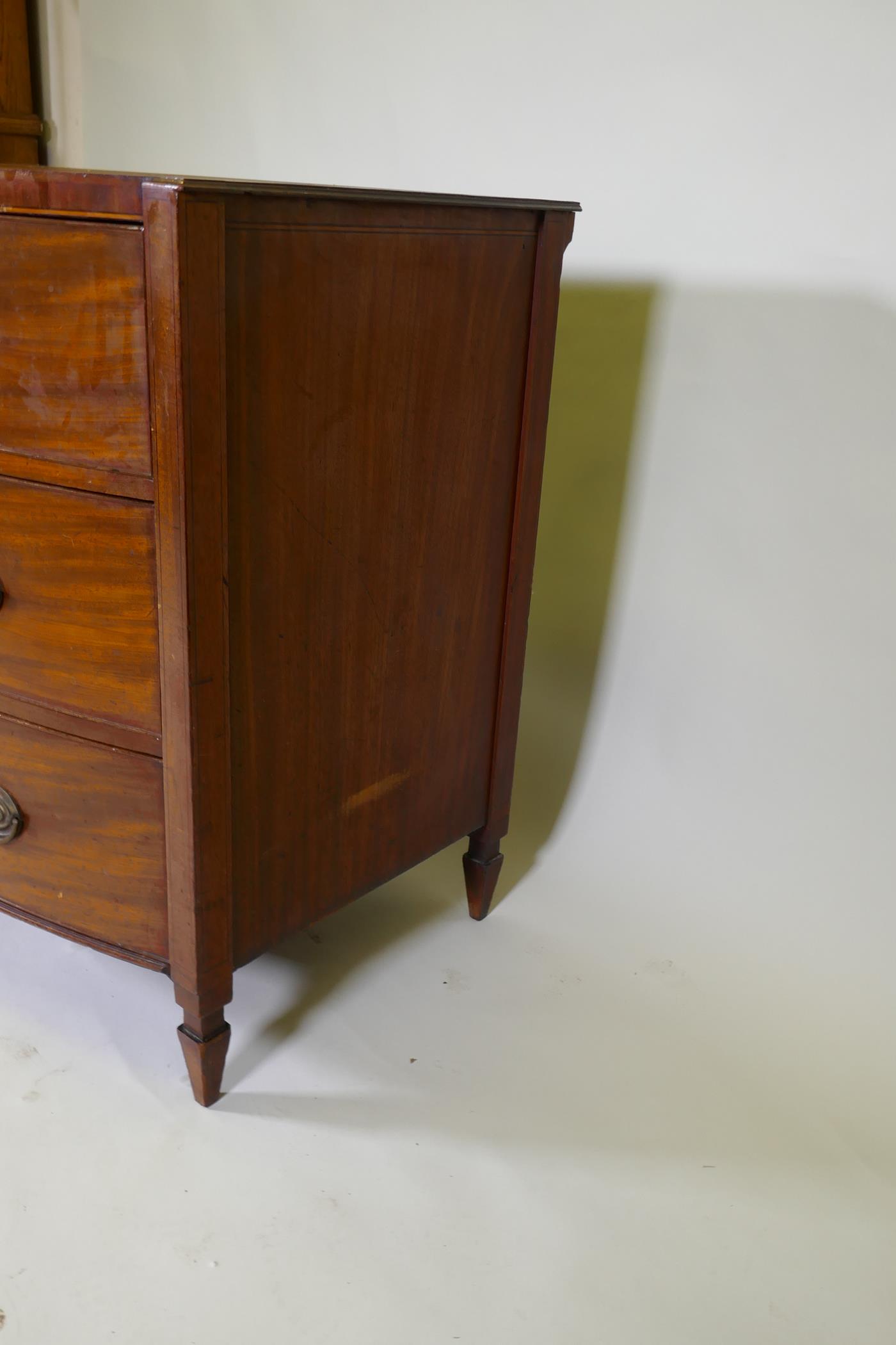 A C19th mahogany Sheraton style bow front chest of three long drawers with brass plate handles, - Image 8 of 9