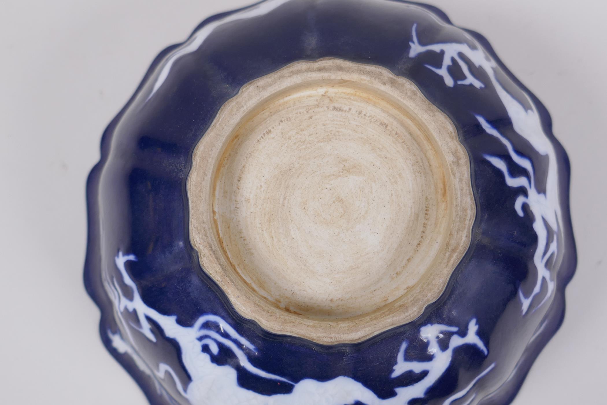 A Chinese blue and white porcelain steep sided bowl with lobed rim, decorated with a white dragon - Image 6 of 6