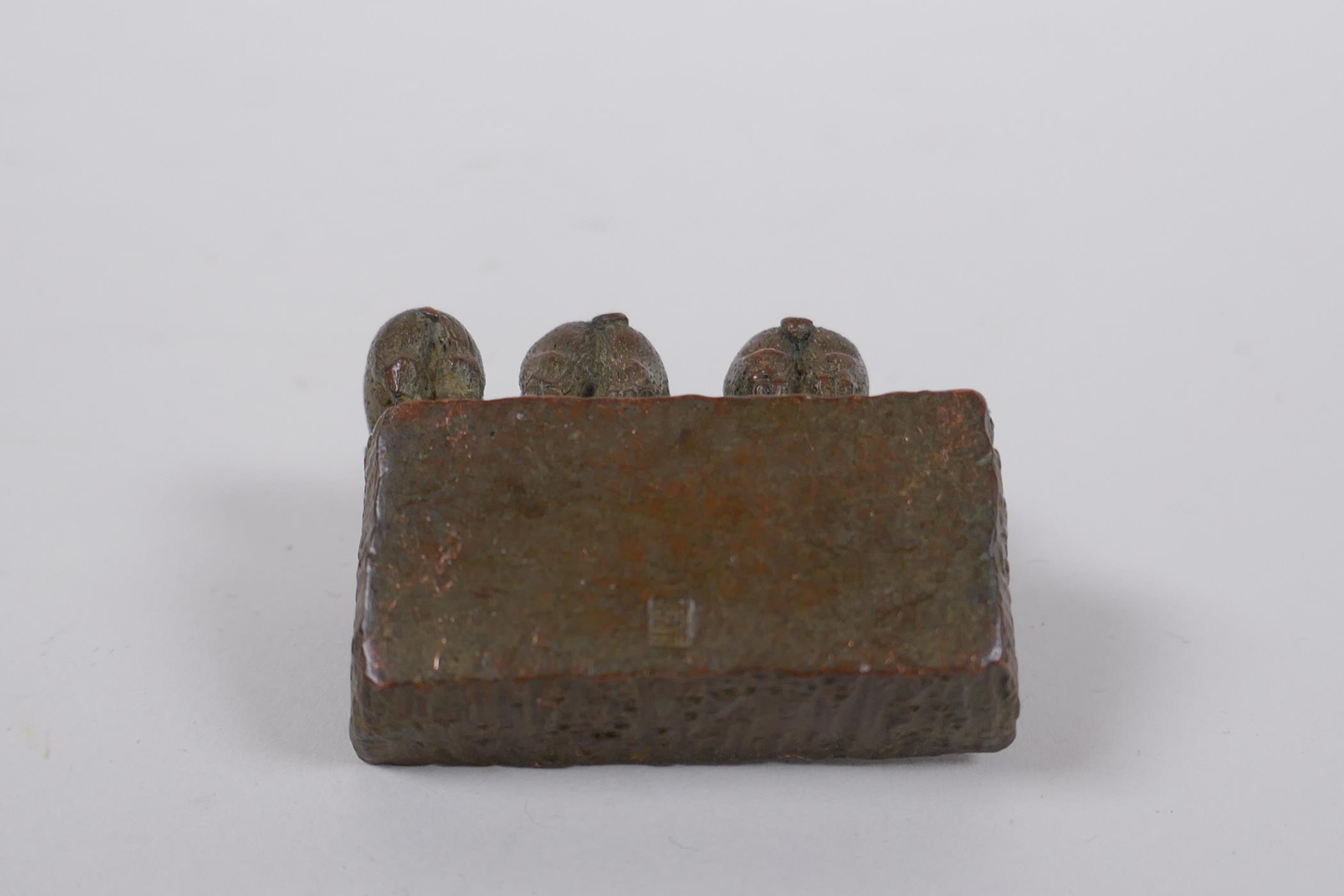 A miniature oriental bronze figure group of pigs at a trough, 5cm long - Image 4 of 4