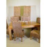A contemporary hardwood dining table and six wicker high back dining chairs, 178 x 90cm, 77cm high