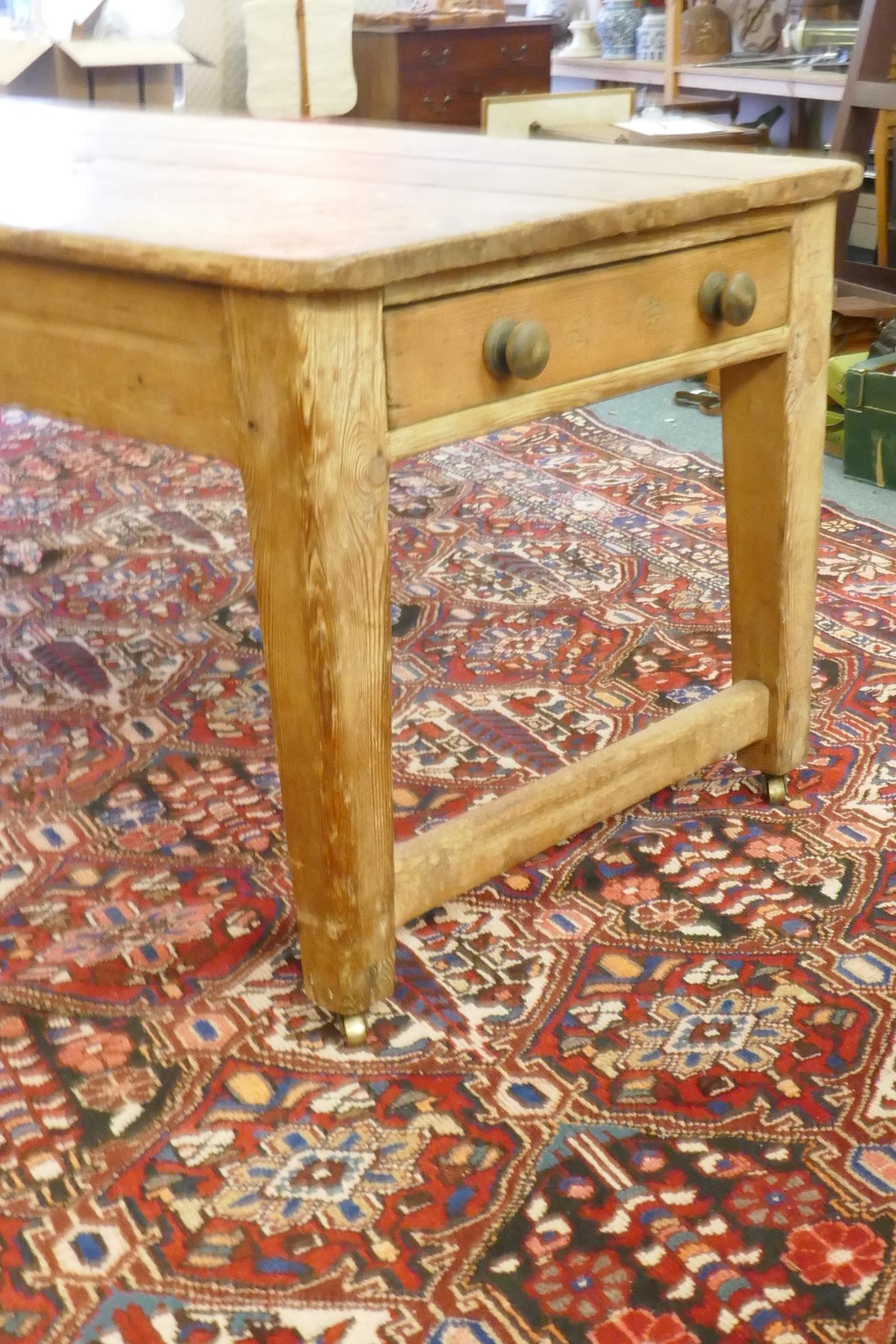 A large Victorian pine scullery table with plank top and end drawers, raised on square tapering - Image 2 of 6