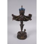 A Tibetan ceremonial bronze phurba ornament in the form of a winged deity, remnants of gilt and