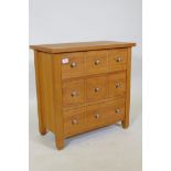 A contemporary oak three drawer chest, the drawers fitted with dividers, 66 x 66 x 35cm