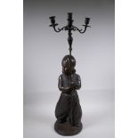 A bronze four branch candlestick in the form of an Arab child, 77cm high