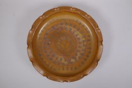 A Chinese brown glazed pottery dish with frilled rim, chased character inscription to the bowl, 4