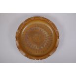 A Chinese brown glazed pottery dish with frilled rim, chased character inscription to the bowl, 4