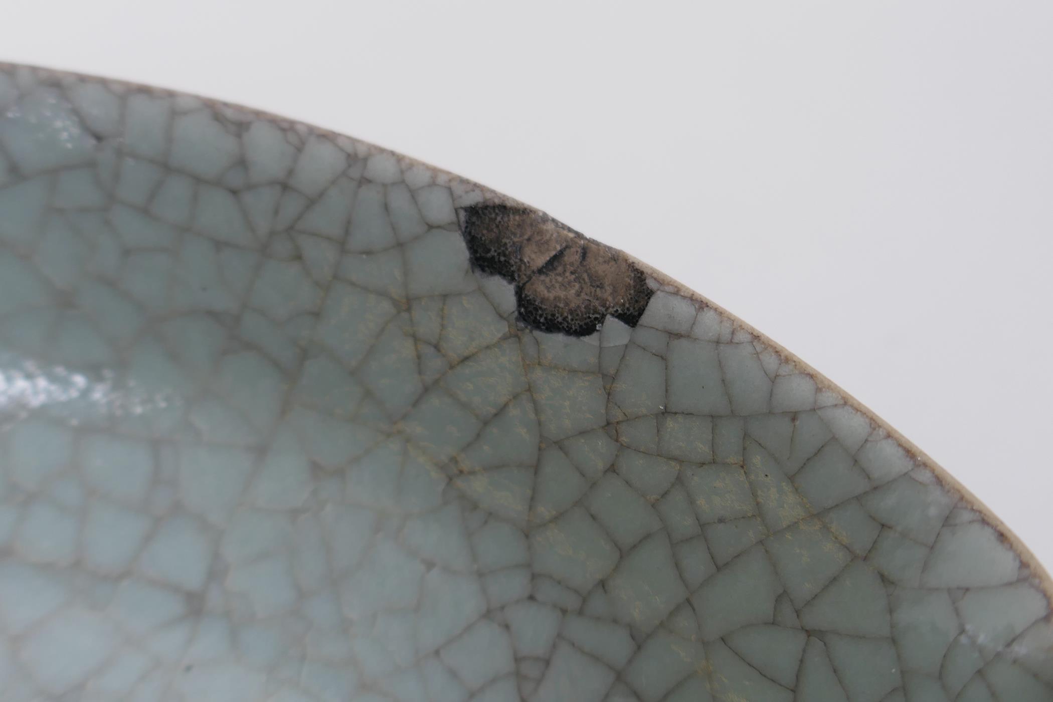 A Chinese celadon glazed porcelain dish with a petal shaped rim, AF, 19cm diameter - Image 3 of 4